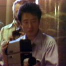 Nam Jun Paik at the camera during a performance of the TV Cello. (video still from photograph: Stephen Jones) Nam Jun Paik at the camera during a performance of the TV Cello. (video still from photograph: Stephen Jones)